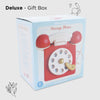 A pastel blue and white box labeled "Vintage Wooden Telephone" displays a red and white retro-style phone. The box reads "Le Toy Van," with leaf and bird designs in the background and "Deluxe - Gift Box" above.