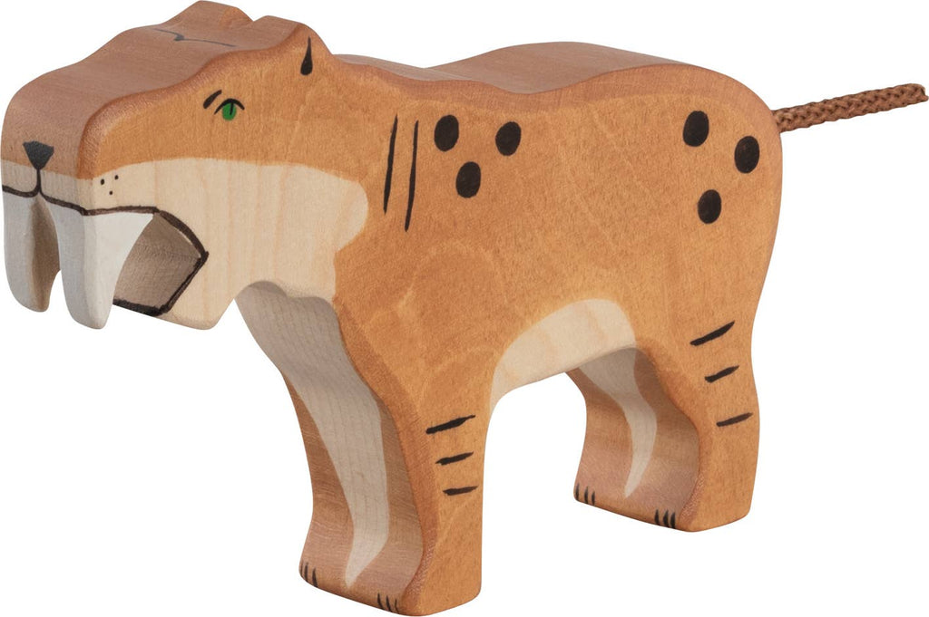 The Holztiger Saber-Toothed Tiger is a handcrafted wooden figure with painted orange fur, black spots, green eyes, long white fangs, and a short tail—lovingly made in Europe as part of the HOLZTIGER collection.