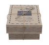 A small, rectangular, brown cardboard box with black vintage-style postal markings and a string—ideal for presenting the eco-friendly Little Wooden French Car baby toy.