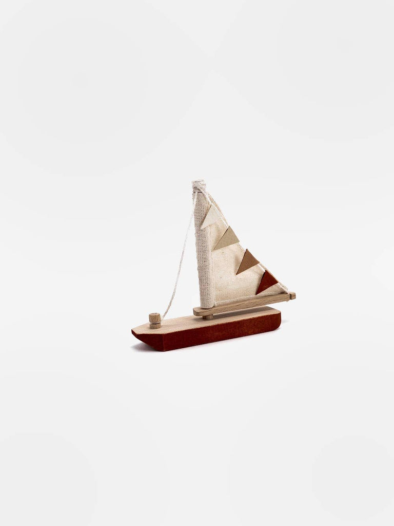 The Handmade Small Wooden Boat, crafted from beech with non-toxic paint, features a brown hull and beige sail decorated with triangular pennants. Made in Ukraine, it is set against a plain white background.