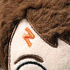 Close-up of a Steiff Harry Potter Plush 11" face featuring brown embroidered hair, an orange embroidered "N" shape on the side of the head, and part of an eyebrow stitched with brown thread.