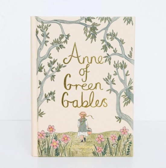 The "Anne of Green Gables: Collector's Edition" hardcover book features a cream cover with an elegant title, depicting a pastoral scene of a girl in a dress and straw hat walking among pink flowers and green trees.