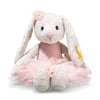 The Steiff Hoppie Rabbit Ballet is a plush ballerina bunny with long floppy ears, dressed in a pink tutu and matching flower headband, sitting upright against a white background.