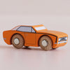The No. 22 GT125 Cami, a small orange classic American muscle toy car with black details and wooden wheels, made in England, is displayed on a light surface.