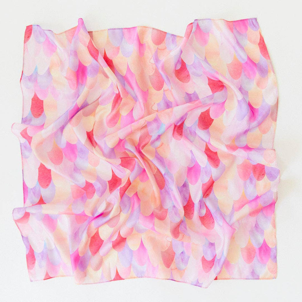 Sarah's Silks Magical Creatures Playsilk - Pink Unicorn is a pure silk square scarf with a crumpled texture and pastel scalloped pattern in pink, purple, peach, and cream—ideal for open-ended play or display on a white surface.