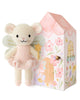 Cuddle + Kind Tiny Lily the Fairy, a hand-knit mouse doll with wings, pink tutu, and star wand, stands beside a pastel house-shaped box decorated with flowers, door, and windows.