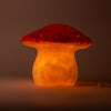 The Red Mushroom Lamp features a whimsical red cap and yellow stem, softly glowing to brighten any dark room—an ideal, charming addition to children's lamp collections.