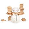 The Balance the Baker Stacking Game features a round wooden chef in a white hat and coat, holding trays with stackable wooden bread and pastries, surrounded by more wooden treats on a white background.