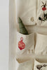 A green, cone-shaped tree sits in a fabric pocket with a red ornament and number 11, part of the Sabo Concept Christmas Cotton Advent Calendar featuring visible numbers 6 and 11.