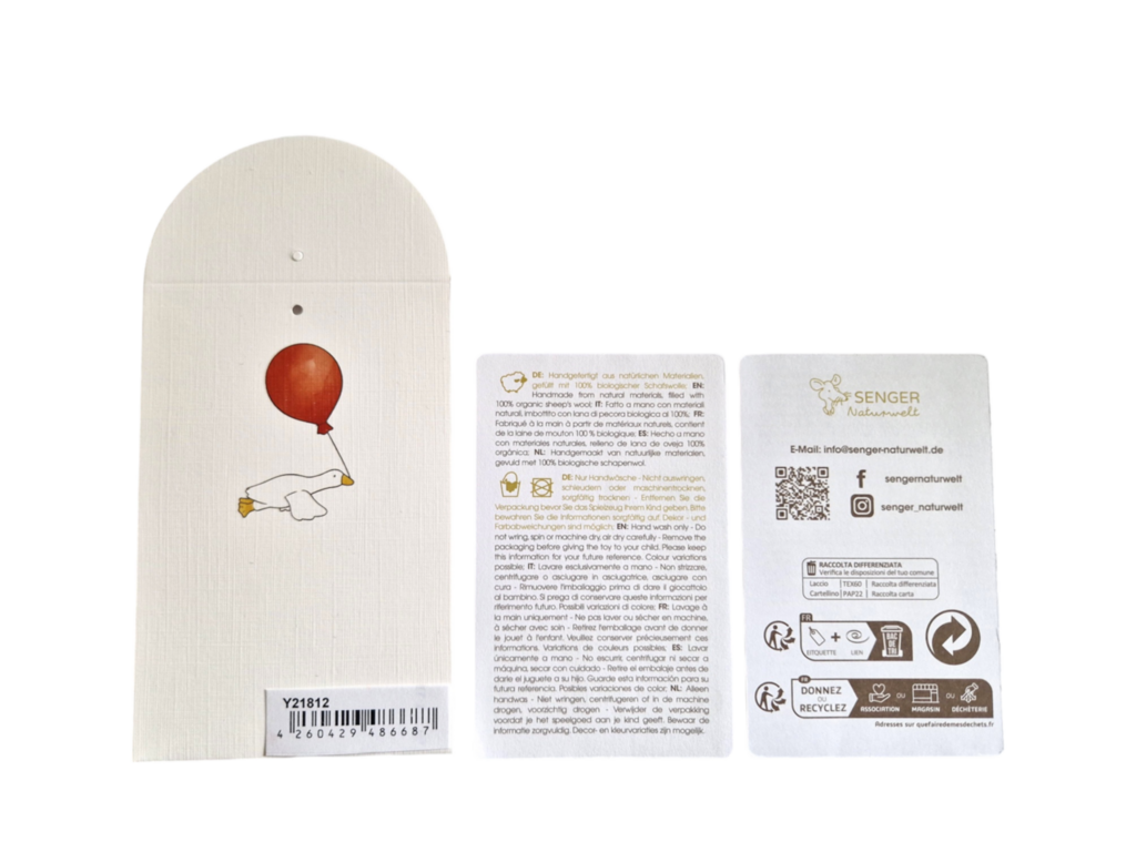 Three tags are displayed: one with an illustration of a white bear holding a red balloon, one with multilingual text, and one featuring the Senger Naturwelt logo, contact info, GOTS-certified and recycling symbols.