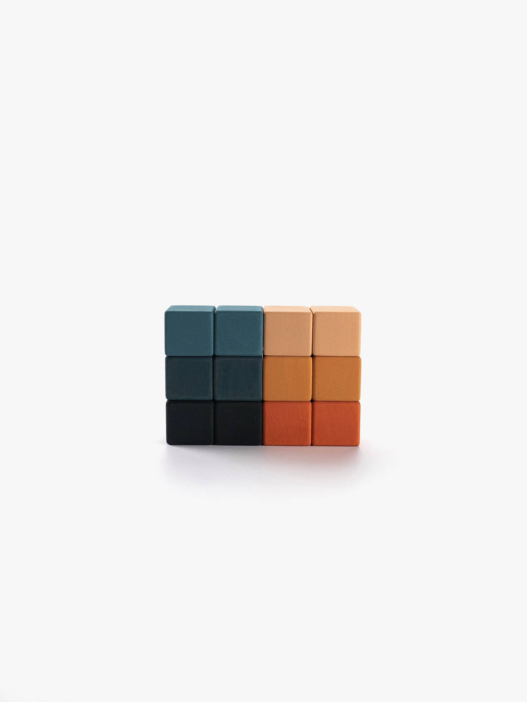 A set of eight Sabo Concept Mini Wooden Blocks – Tropics, arranged in two neat rows on a white background, features vibrant shades of blue, black, peach, and orange—making them ideal educational toys for developing fine motor skills.