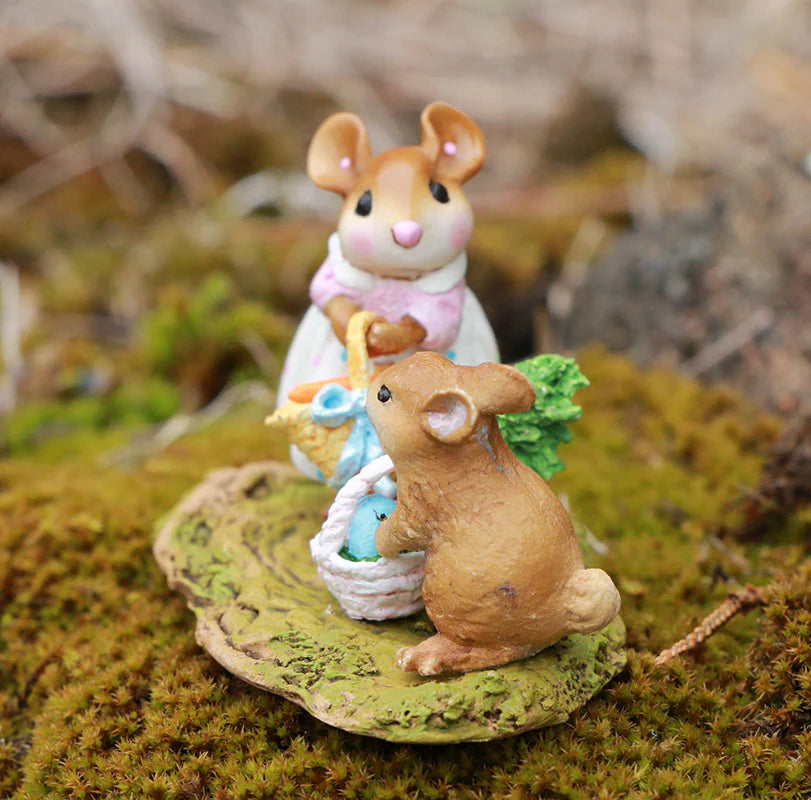 The Wee Forest Folk Tiny Collectible - Baskets Full of Easter Joy features two hand-sculpted mice on a mossy surface, one standing with a basket and the other sitting with a white basket and tree, creating a charming woodland scene.