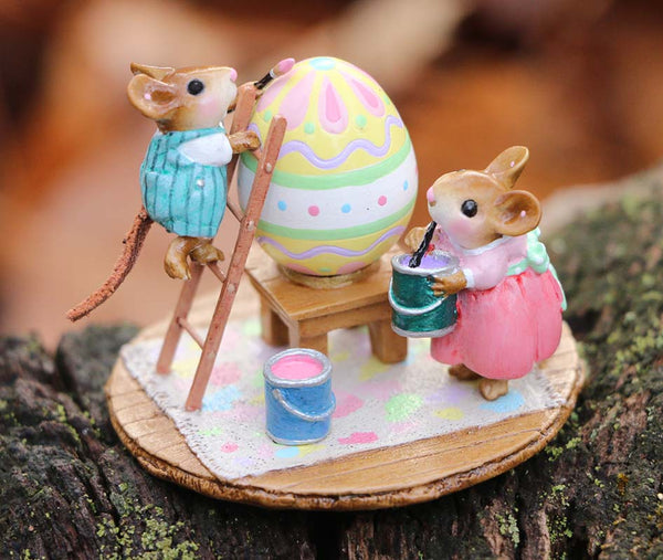 The Wee Forest Folk Tiny Collectible - Colossal Easter Coloring features two hand-sculpted mice: one in green overalls paints a giant egg atop a ladder, while another in a pink dress holds paint beside the egg on a mat over wood.