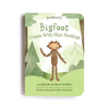 A book cover titled "Slumberkins Bigfoot Kin + Lesson Book On Self Esteem" by Kelly Oriard with Callie Christensen, featuring an illustration of Bigfoot standing among green trees, a theme of self-esteem.