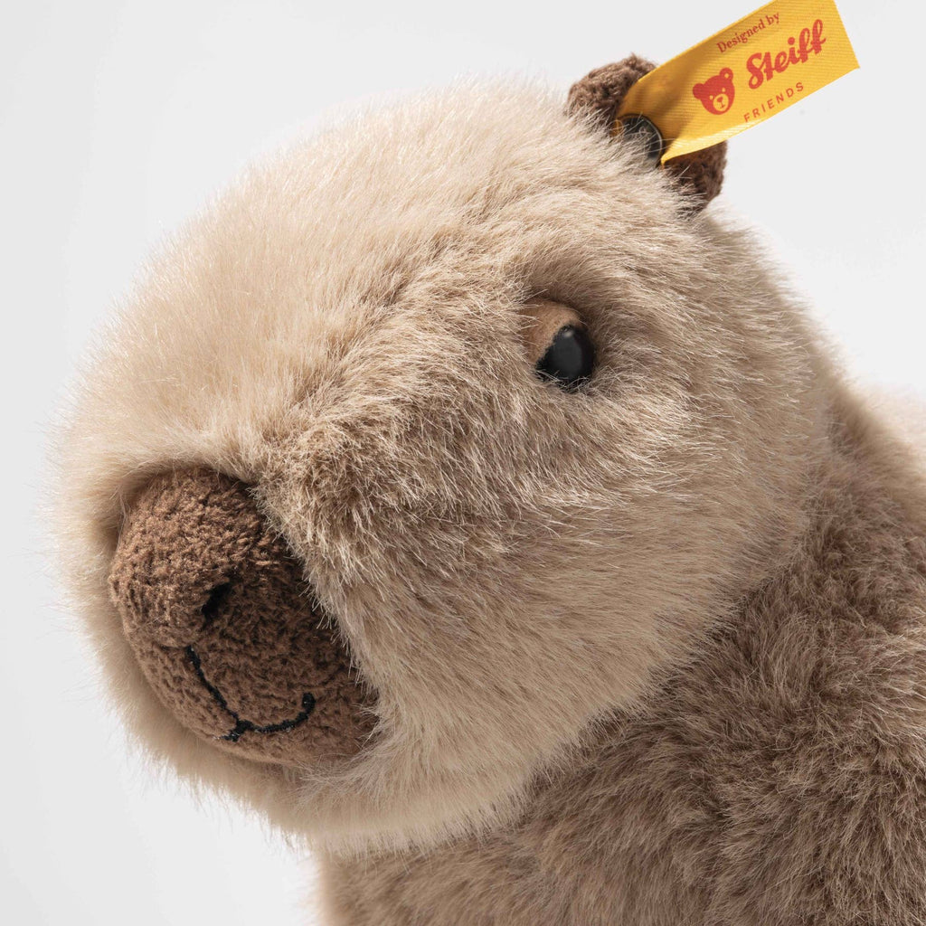 A close-up of the Steiff Chip Capybara plush with soft beige and brown fur, a stitched nose, and a yellow "Steiff" ear tag, shown on a plain white backdrop—perfect for plush toy or chip capybara collectors.