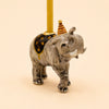 The Elephant Cake Topper - Final Sale (ships in one week) features a hand-painted elephant with a striped party hat, black blanket with gold stars, and a yellow candle—perfect as a collectible keepsake.
