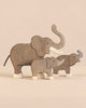 Holztiger Handmade Wooden Elephant Family Set consisting of three handcrafted wooden elephant figures of varying sizes, each with light-colored feet.