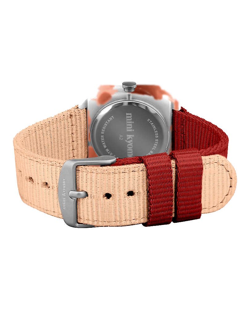 The Mini Kyomo Watch - Cinnamon Roll features a beige and red woven strap shown from the back, with an engraved metal buckle and branded text on the watch case.