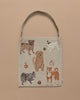 The Dogs and Toys Tote showcases a beige canvas with embroidered images of five dog breeds on a light brown backdrop, complemented by small, playful items enhancing its charm.