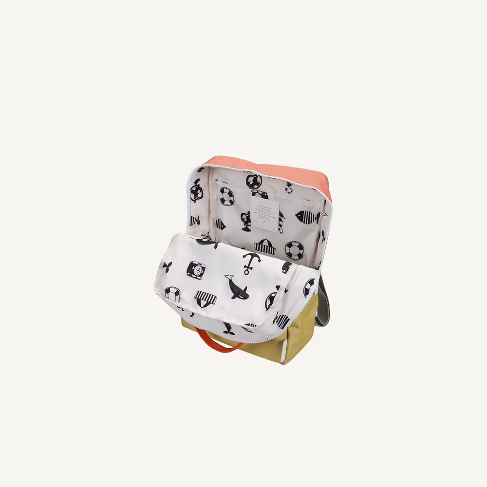 The Sticky Lemon Backpack Large | Color Blocking | Coral Pink + Reed Green features a white interior lining with playful black animal, umbrella, and soccer ball illustrations—crafted from recycled PET bottles for a sustainable, colorful kids' backpack.