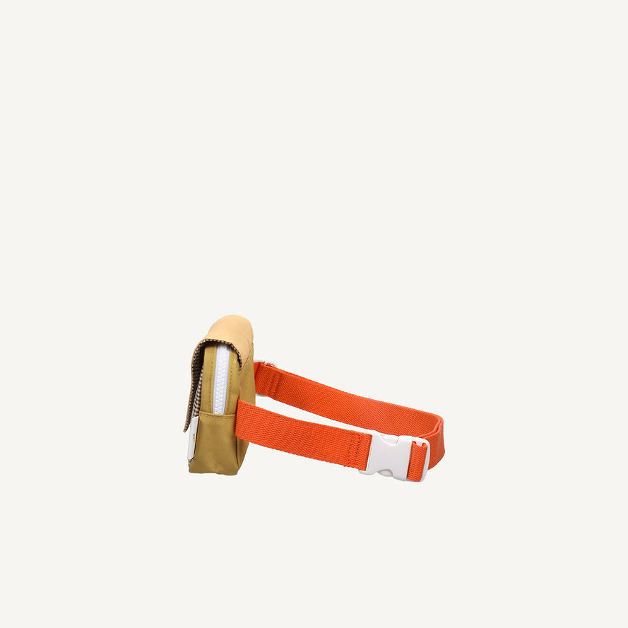 The Sticky Lemon Fanny Pack Small - Envelope - Apple Juice is a tan pack with a white zipper, orange adjustable strap, and white buckle. Made from recycled PET bottles with a waterproof lining, it's shown on a plain white background.
