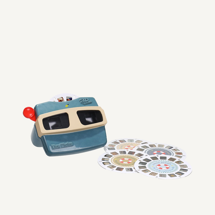 The Sticky Lemon Viewmaster - Wonders of the Deep Sea, in teal and beige with a red lever and dual eyepieces, sits beside round image reels on a white background.