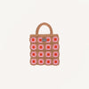 Introducing the Sticky Lemon Crochet Bag - Lemon Tree - Flower - Campfire Orange: a delightful crochet accessory with a tan handle and body, adorned with a playful grid of campfire orange and pink flower squares against a crisp white background. Designed in the signature whimsical style of Sticky Lemon, this bag radiates cheerful vibes and makes the perfect playful carryall for kids.