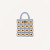 Inspired by Sticky Lemon, the Sticky Lemon Crochet Bag - Lemon Tree - Flower - Willow Basket is a delightful kids’ crochet bag adorned with a blue border and handles, and beautifully decorated with a yellow and brown sunflower grid motif.