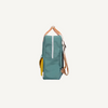 A side view of the Sticky Lemon Backpack Large | Envelope | Diving Suit in teal, made from recycled PET, with a white vertical zipper, yellow front pocket, striped adjustable strap, and waterproof lining against a plain white background.