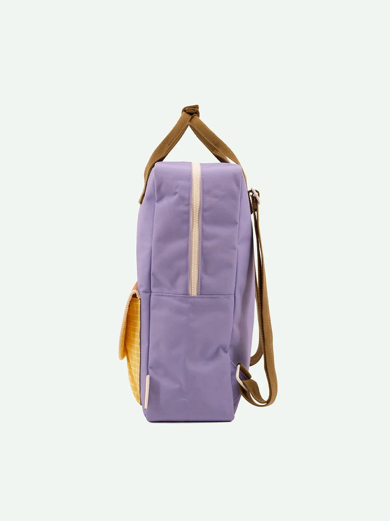 A side view of a Sticky Lemon Backpack Large in Blooming Purple, made from recycled RPET, with brown straps and zippers, isolated against a white background.