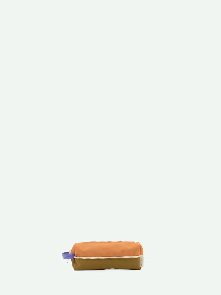 An orange Sticky Lemon pencil case with a purple YKK zipper, positioned horizontally against a plain white background.