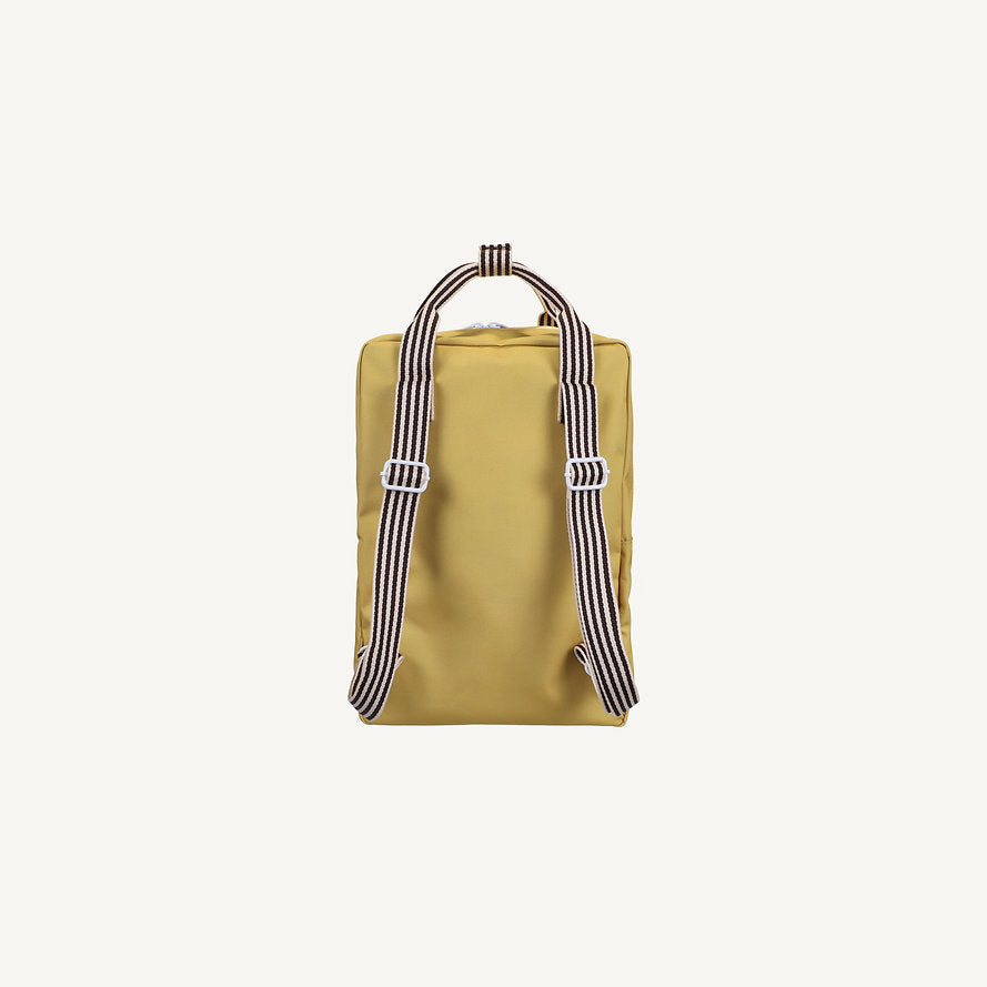 A rectangular Sticky Lemon Backpack Large – Envelope in reed green, crafted from recycled PET bag material with black and white striped adjustable shoulder straps, is shown standing upright against a plain light background.