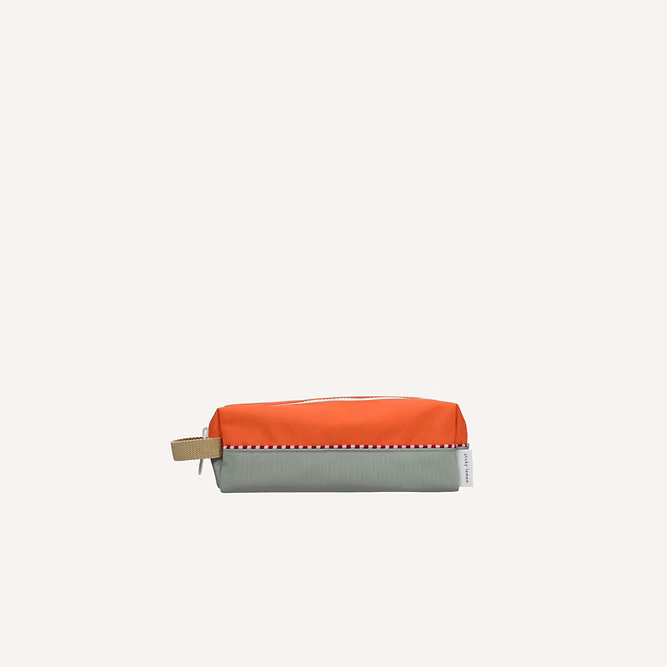 The Sticky Lemon Pencil Case | Color Blocking features a rectangular design in Lifebuoy Orange and Shark Grey with a beige side strap and visible YKK zipper, set against a plain light background.
