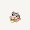 The Sticky Lemon Backpack Small - Special Edition - Snail Mail is a small beige bag with yellow handles, a red geometric pattern, an open flap revealing a white interior with black abstract shapes, plus a yellow tag and waterproof lining made from recycled PET bottles.