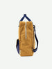 A Sticky Lemon Backpack Large made from waterproof nylon with a vertical zip, blue accents, and a detachable shoulder strap, shown against a white background.