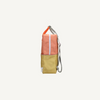 The Sticky Lemon Backpack Large | Color Blocking | Coral Pink + Reed Green features a side view with a coral pink top, reed green bottom, white zipper, patterned trim, silver adjustable strap, and waterproof lining for belongings.