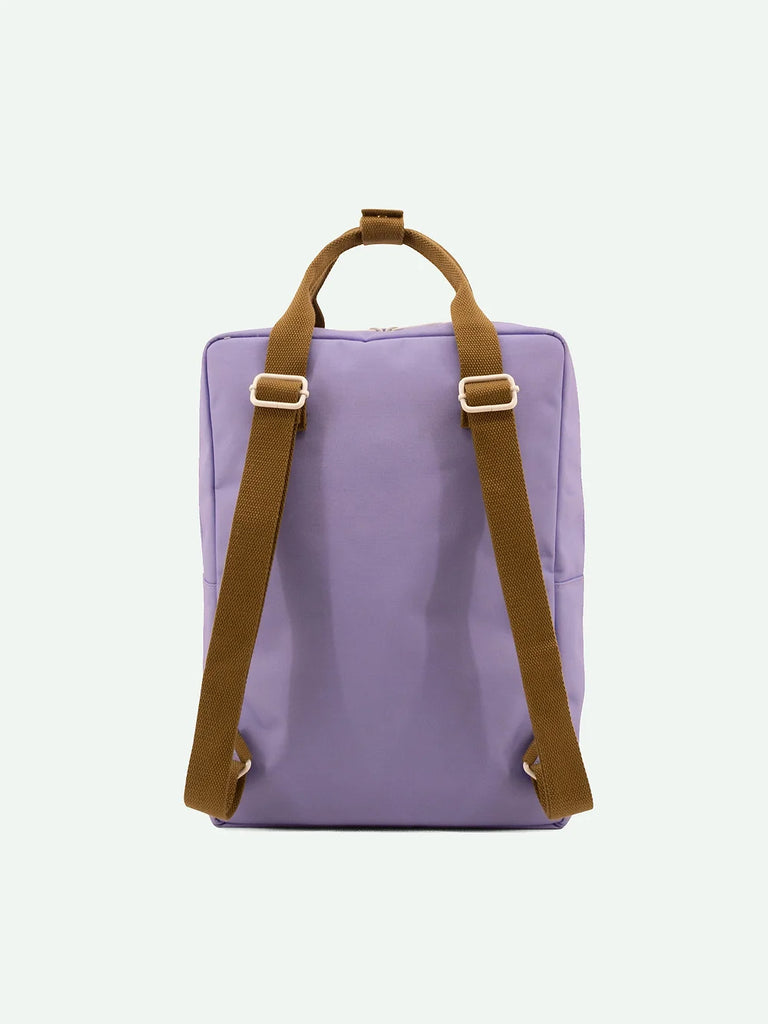 A simple Sticky Lemon Backpack Large in Blooming Purple made of recycled RPET with brown straps, displayed against a white background.