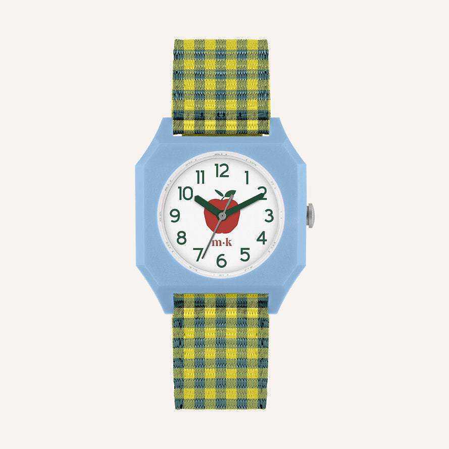 The Sticky Lemon x Mini Kyomo Watch - Apple features a light blue square case, white dial with a red apple, green numbers, black hands, and "m-k" logo. A yellow-green plaid fabric strap completes this playful kids' watch.