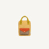 The Sticky Lemon Backpack Small - Envelope - Apple Juice is a yellow kids backpack with green handles, a front pocket with a red flap and brown-and-white checkered design, made from recycled PET bottles and shown on a plain white background.