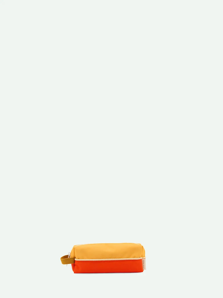 A Sticky Lemon pencil case with a Pear Jam + Ladybird Red zipper, positioned horizontally, isolated against a light grey background.