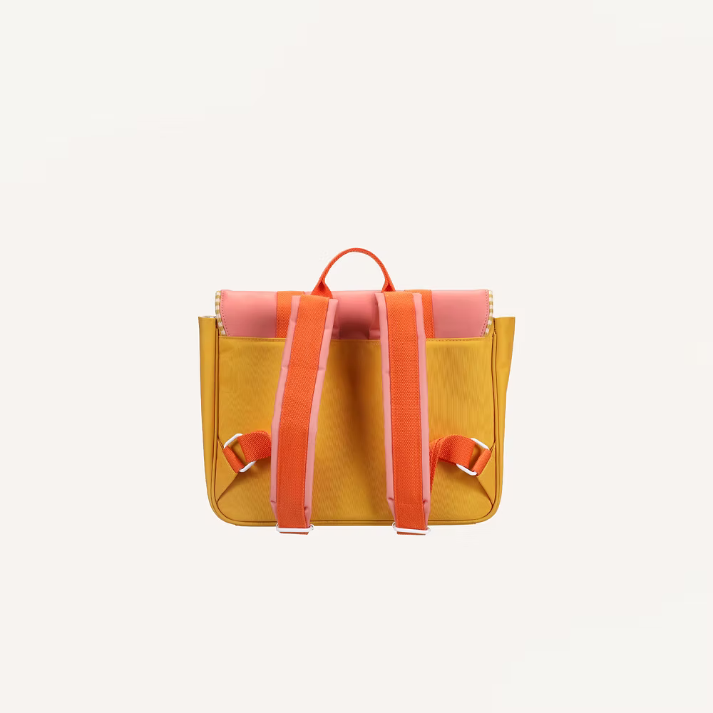 The Sticky Lemon School Bag | Coral Pink + Submarine Yellow is shown from the back, displaying orange straps and pink trim, with a waterproof nylon lining, all set against a plain white background.