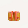 The Sticky Lemon School Bag | Coral Pink + Submarine Yellow is shown from the back, displaying orange straps and pink trim, with a waterproof nylon lining, all set against a plain white background.