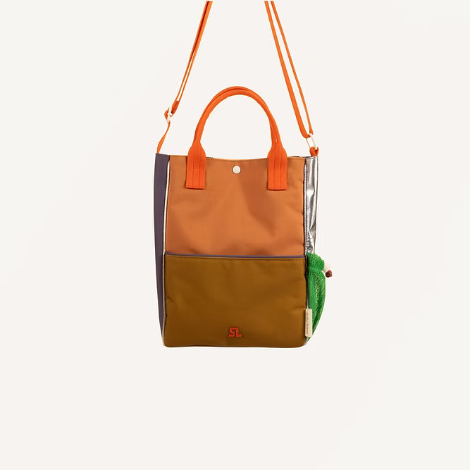 The Sticky Lemon Shoulder Bag | Leather Ball + Golden Cup features brown, orange, green, and purple color-block panels made from recycled PET bags, orange handles and strap, a snap closure, and an attached green pouch.