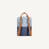 The Sticky Lemon Backpack Large | Color Blocking | Bissou Blue + Blue Whale is a two-tone kids backpack made from recycled PET bottles, with a light blue top, dark blue base, and brown adjustable straps and handle, shown from the back on a white background.