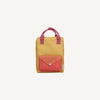 The Sticky Lemon Backpack Medium - Envelope - Apple Grub is a small yellow backpack with pink handles, a front pocket with a red flap and red-and-white checkered pattern, made from recycled PET bottles and featuring a waterproof lining on a plain light background.