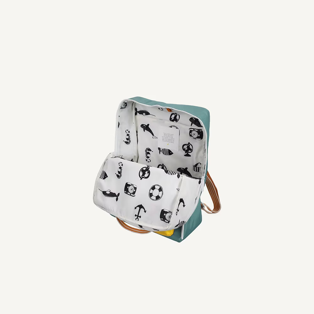 The Sticky Lemon Backpack Large | Envelope | Diving Suit is an open teal kids backpack with tan straps and a white interior lining featuring black illustrations. The waterproof lining is made from recycled PET bottles.