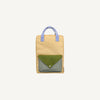 The Sticky Lemon Backpack Large - Envelope - Twiggy Beige is a rectangular beige kids' backpack with light blue handles, green front pocket flap, mesh-patterned section, and is made from waterproof recycled PET bottles. Shown on a white background.