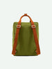 A Sticky Lemon Backpack Large in Sprout Green with contrasting orange straps made of cotton webbing and silver buckles, displayed against a neutral background. The backpack appears sturdy and compact, suitable for casual use.