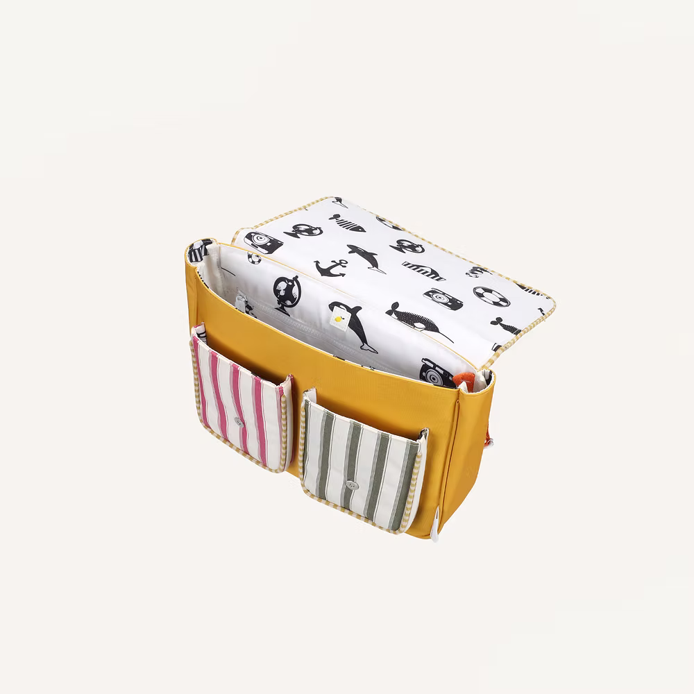 The Sticky Lemon School Bag | Coral Pink + Submarine Yellow features a yellow backpack design with two front pockets—one pink-striped, one green-striped—and a flap lined with black and white animal illustrations.