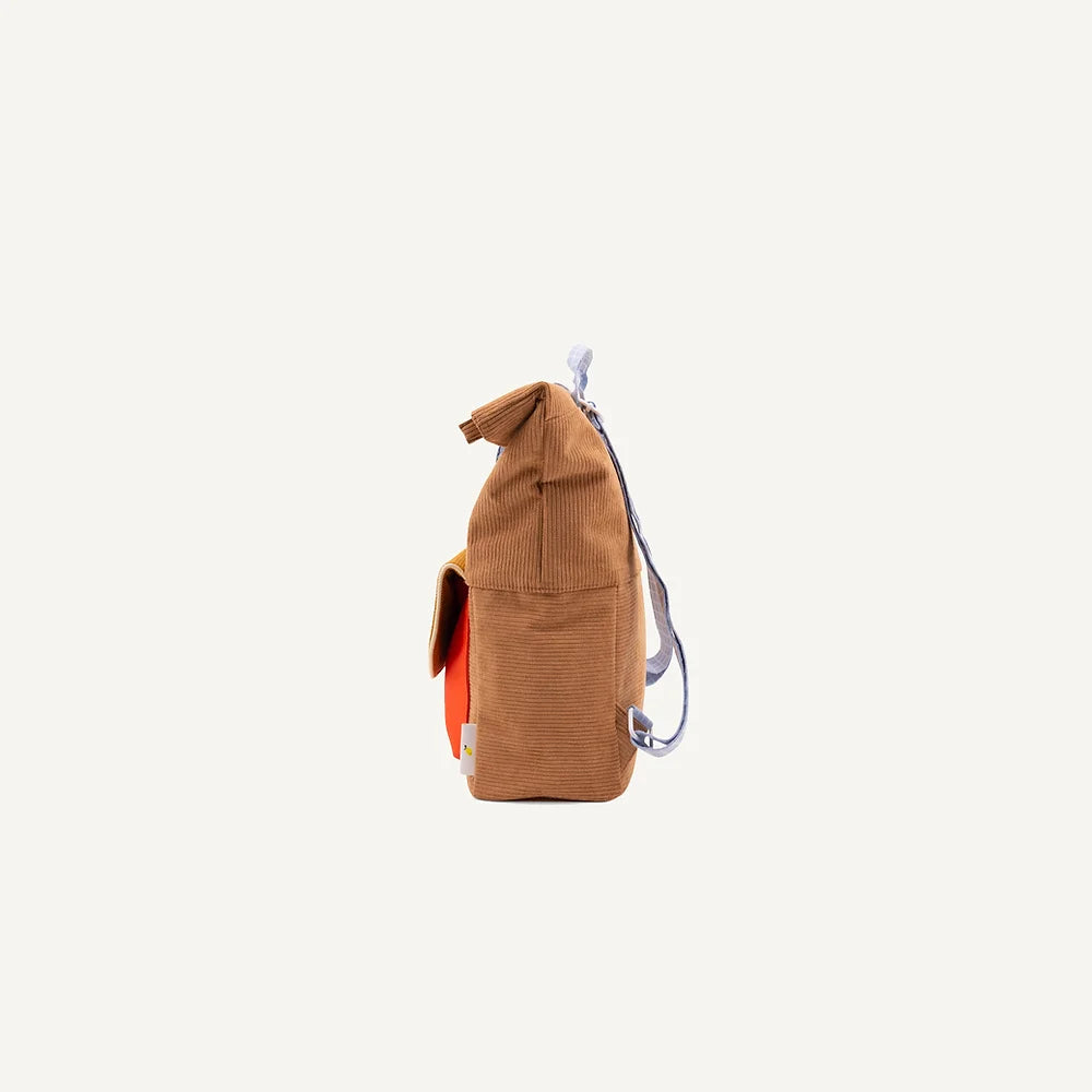 A small, upright Farmhouse corduroy backpack with an orange interior and a zipper on a white background. The backpack's strap is partially visible, looped at the top.